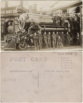 CPR workers standing on and around a train engine at the work yards