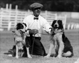 Man kneeling with two dogs