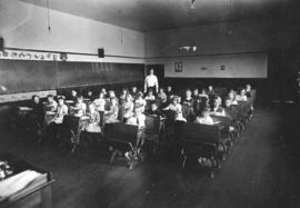 [Children sitting at their desks in a class at Shaughnessy School at the corner of Oak Street and...