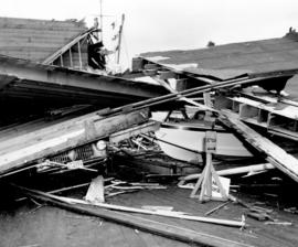 [Car and boat under the wreckage of the Evans, Coleman and Evans Wharf]