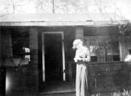 [Woman standing in front of the Seldom Inn at Summit Lake]