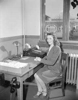 [B.C. Telephone employee at her desk]