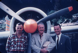 Kendan McCuaig and two men in front of plane propeller