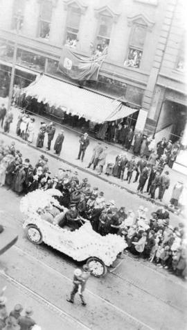 [View of decorated Hudson Bay Co. car in a parade on Hastings Street]