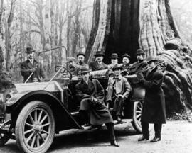 Group of men with car at the Stanley Park Hollow Tree