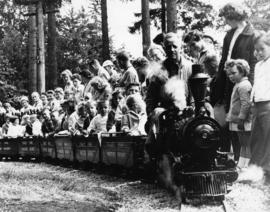 Crowd of children and adults gathered around the old miniature railway at Stanley Park