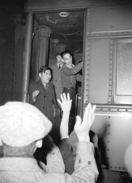 [Japanese Canadians entering train while friends and family wave from train platform]