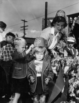 Woman and young girl wearing souvenir hats on P.N.E. grounds