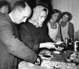 [Hungarian refugees help themselves to food in the Immigration Building at the airport]
