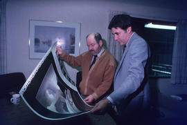 Toni Onley (left) and man examine his Centennial Art Series print at Agency Press