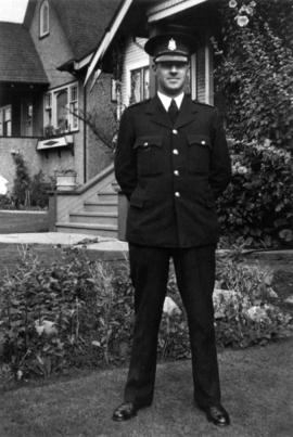Constable Charles (Chuck) Blythe in his Vancouver City Police uniform in front of his parent's ho...