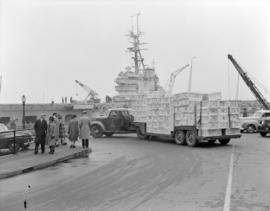 [Red Cross supplies being delivered to a naval ship]