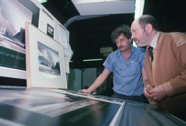 Toni Onley (right) and man examine his Centennial Art Series print at Agency Press