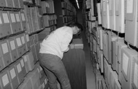 Conservator Sue Bigelow working in the stacks at the City of Vancouver Archives