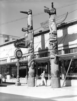[View of totem poles in front of Billingsley Jeweler, Ketchikan, Alaska]