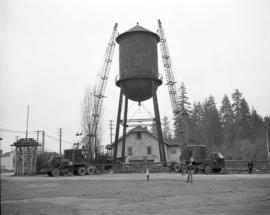 [Cranes finished manoeuvering the cap of a water tower into position]
