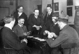 [James Crookall playing cards with a group of men]