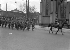 68th C.F.A. [soldiers marching behind officer on horseback]