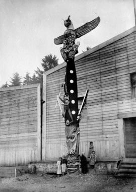 Children with Kwakwaka'wakw Totem Pole outside of Longhouse