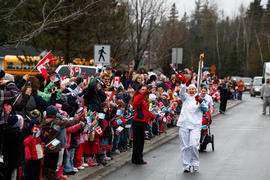 New Day 27 Torchbearer 57 Diana Steeves runs the flame past a crowd in Oromocto, New Brunswick.
