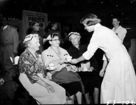 Women served tea in Pure Foods building