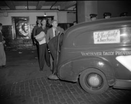 [Men loading newspapers into a Vancouver Daily Province truck under the watchful eye of police of...