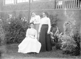 [Mrs. Robert Scott (seated) and two unidentified women assembled outside Scott residence at south...