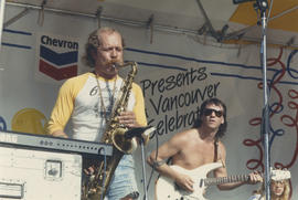 Saxophonist and guitarist perform on Chevron Stage