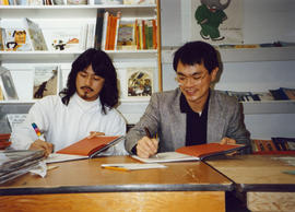 Paul Yee and illustrator Simon Ng signing copies of Tales from Gold Mountain at Children's Book C...