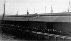 [Unidentified dock filled with people]