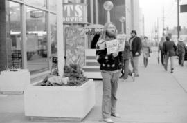 Man sells magazines outside the Vancouver Public Library