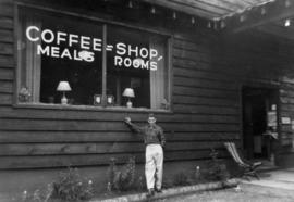 [Joseph Selsey in front of a building with sign - coffee, shop, meals, rooms]