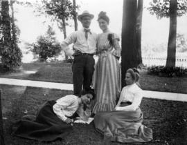 [Caroline Little Pierce outdoors with two unidentifed women and a man]