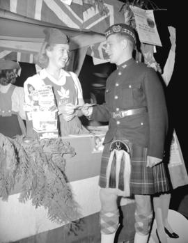 Cadet Butch Bee and Miss Canada [at war savings stamp booth]