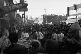 Spectators and parade participants on Pender Street in Vancouver Chinatown