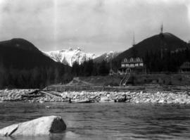 [View of the Capilano Hotel and The Lions in the background from the river]