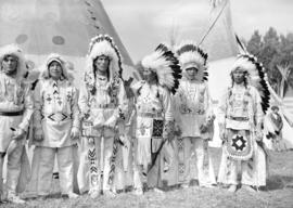 [Group portrait of Stoney Indian Chiefs in traditional costumes at the Calgary Stampede]