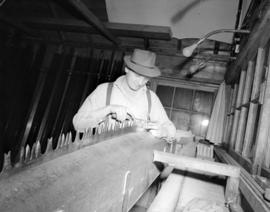 [Man adjusting saw blade at] Pacific Mills [on the] Queen Charlotte Islands