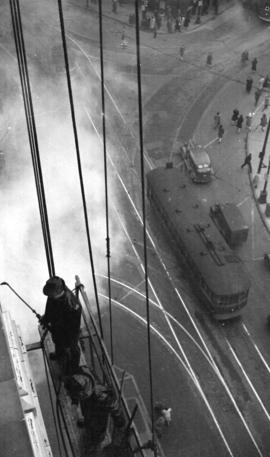 [Workers cleaning the exterior of the Dominion Bank Building]