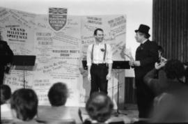 Unidentified man and Harry Rankin deliver theatrical presentation