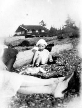 [Small child sitting on beach at Summit Lake]