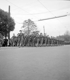[Women in uniform marching in a military parade along Burrard Street]