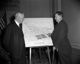 [Two men looking at a drawing for a proposed civic centre site]