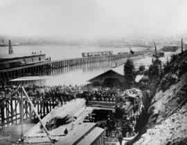 [Crowds at C.P.R. station viewing the arrival of the] first train in Vancouver