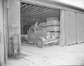 [Evans, Coleman and Evans delivery truck being loaded in a warehouse]