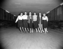 [Group of women roller skating in a line at the Vancouver Skating Club]