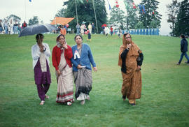 Four women walking across field during the Centennial Commission's Canada Day celebrations