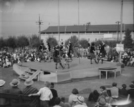 Canada Pacific Exhibition [Highland dancers performing on stage with a crowd watching]