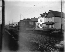 [View of 1000 block of Robson Street, showing streetcar and James Stark residence]