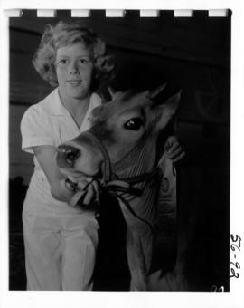 Girl with award-winning Jersey cow from 1956 P.N.E. 4-H and Future Farmers of Canada competition